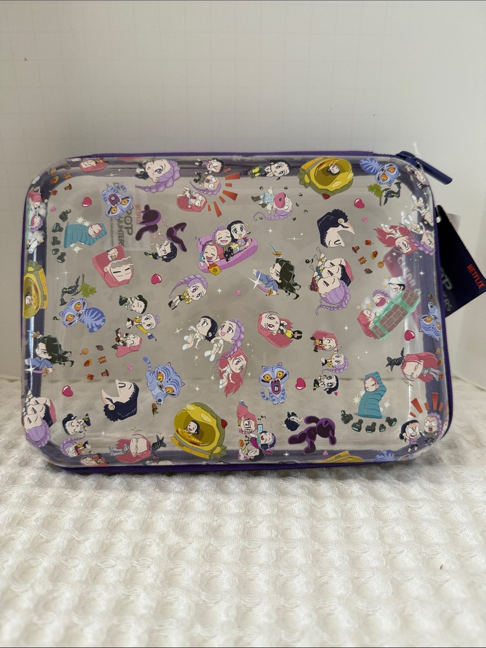 Netflix K-POP Demon Hunters Chibi-Style Clear PVC Pencil Case with Purple Trim.